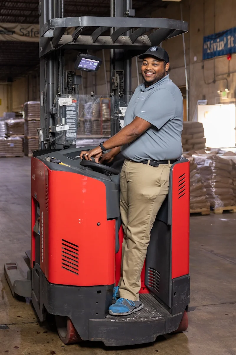 jrw-worker-smiling-on-fork-lift-pet-food